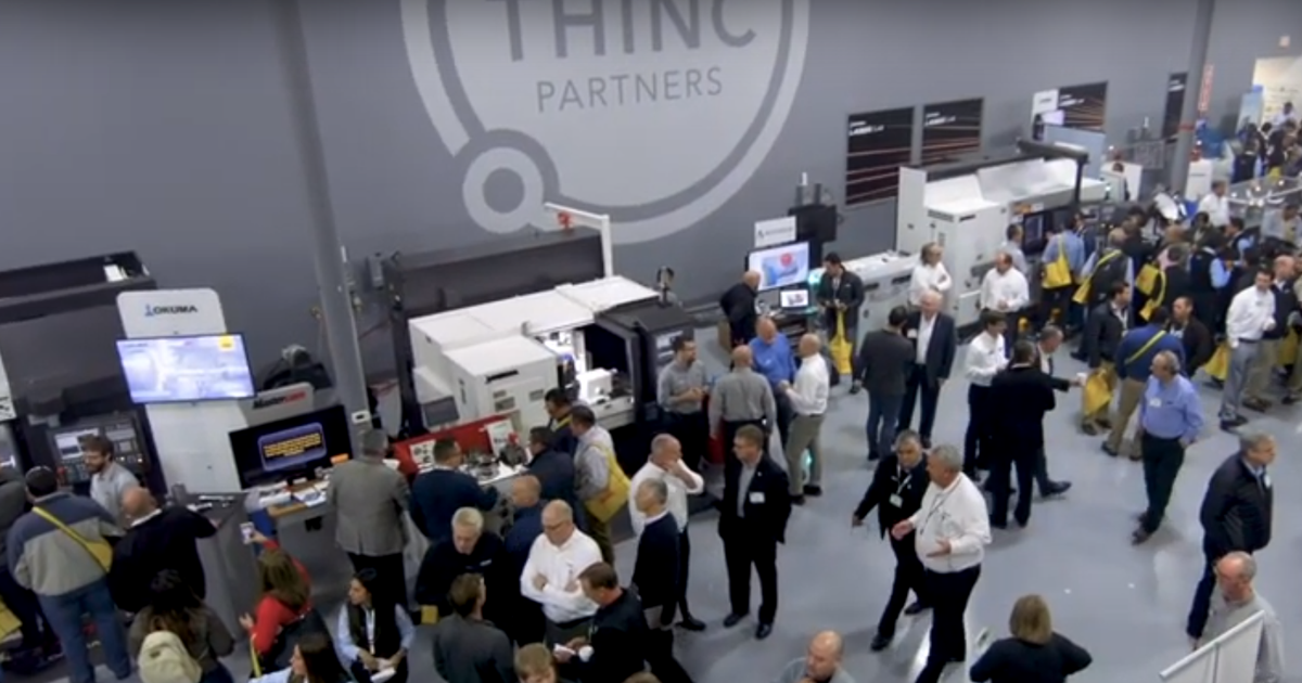 crowd around cnc machines at the 2019 Okuma Summer Showcase